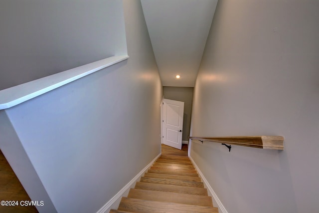 stairway with hardwood / wood-style floors