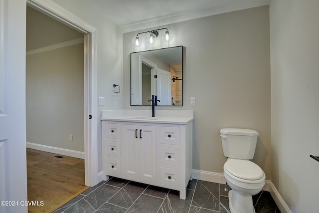 bathroom featuring vanity, hardwood / wood-style floors, and toilet