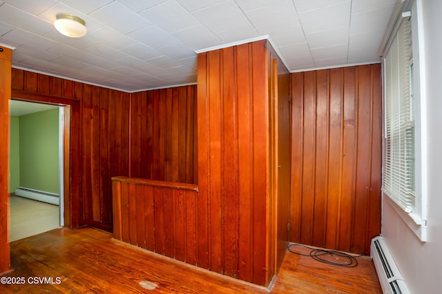 1243 Upper Mulberry St, Danville, PA 17821 - hallway featuring baseboard heating, wood finished floors, and wooden walls