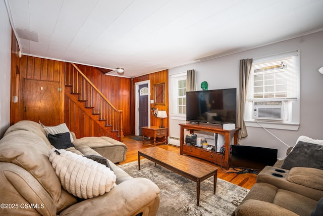 1243 Upper Mulberry St, Danville, PA 17821 - living room featuring stairway, wood walls, baseboard heating, wood finished floors, and crown molding