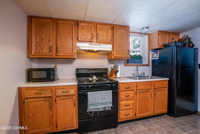 1243 Upper Mulberry St, Danville, PA 17821 - kitchen featuring black appliances, under cabinet range hood, a sink, light countertops, and brown cabinetry