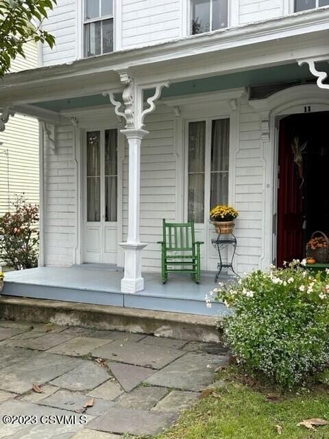 view of exterior entry with a porch