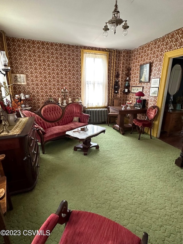 living room with an inviting chandelier, dark carpet, and radiator heating unit