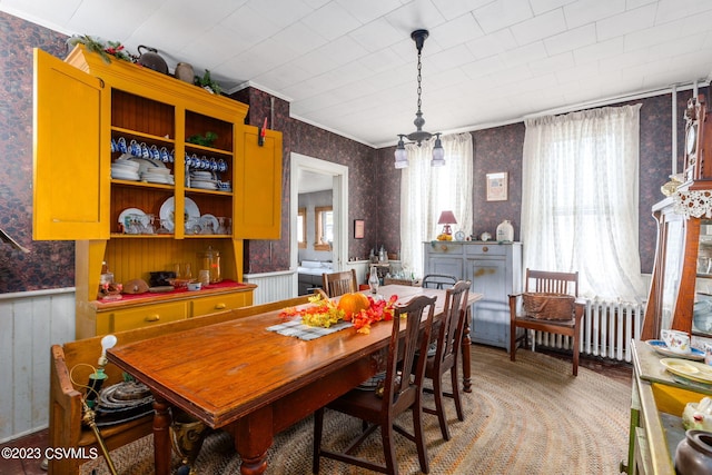 dining space featuring a notable chandelier, radiator, and plenty of natural light