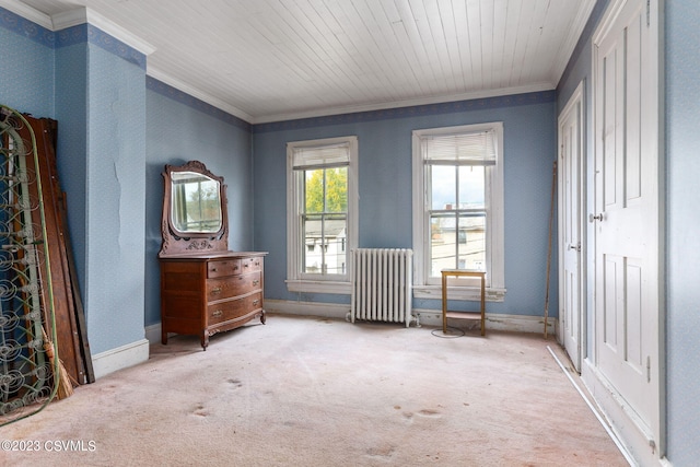 interior space with radiator, ornamental molding, and light colored carpet