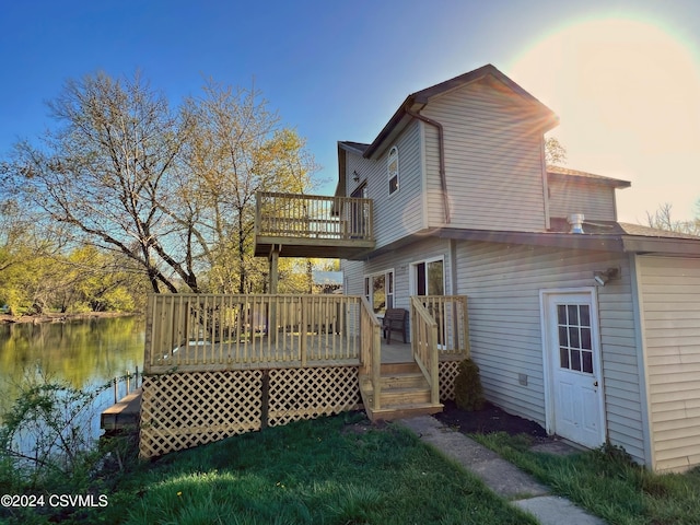 back of property with a deck with water view