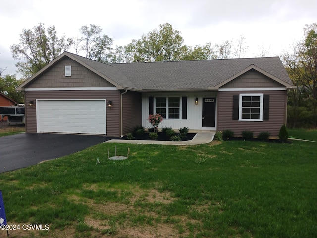 ranch-style home with a garage and a front yard