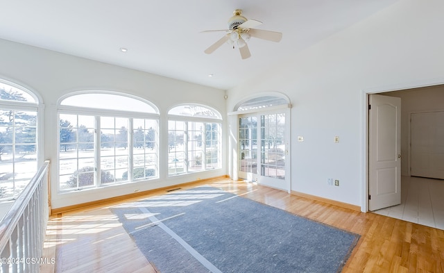 interior space with ceiling fan, lofted ceiling, and light hardwood / wood-style floors