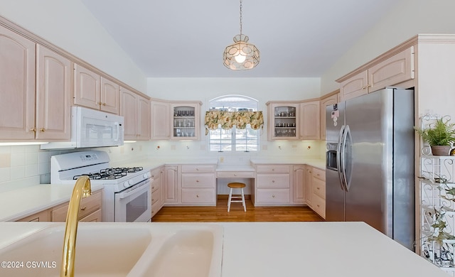 kitchen featuring tasteful backsplash, white appliances, light wood-type flooring, and light brown cabinetry