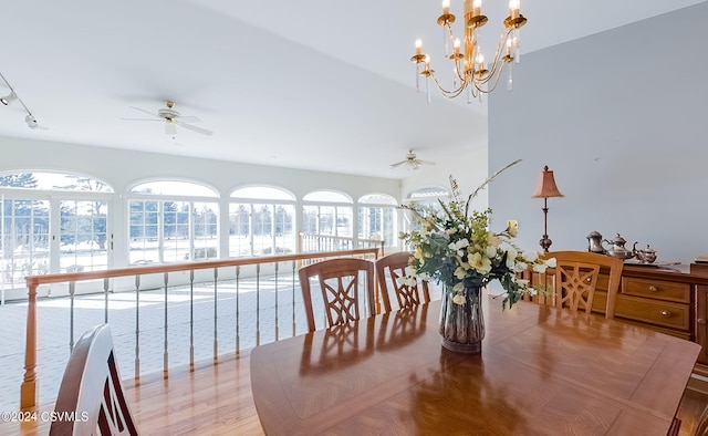 dining area featuring ceiling fan with notable chandelier and rail lighting