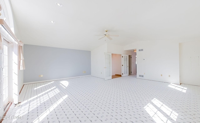 empty room with lofted ceiling, light colored carpet, and ceiling fan