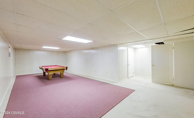 rec room featuring a paneled ceiling and concrete floors