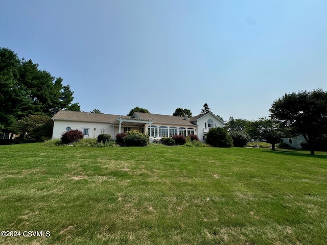 ranch-style house with a pergola and a front yard