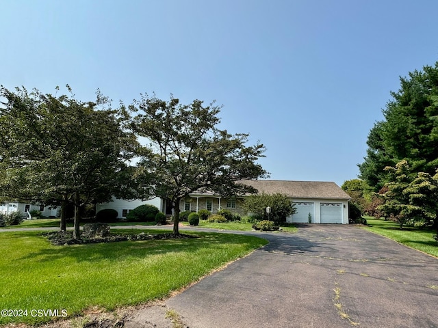 single story home featuring a front lawn and a garage