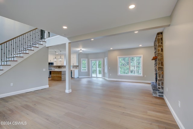 unfurnished living room with light hardwood / wood-style flooring