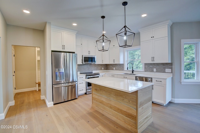 kitchen featuring sink, stainless steel appliances, light hardwood / wood-style flooring, and tasteful backsplash