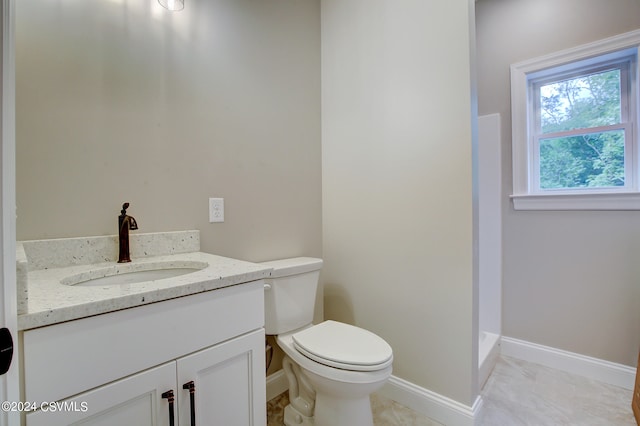 bathroom featuring tile patterned flooring, vanity, and toilet