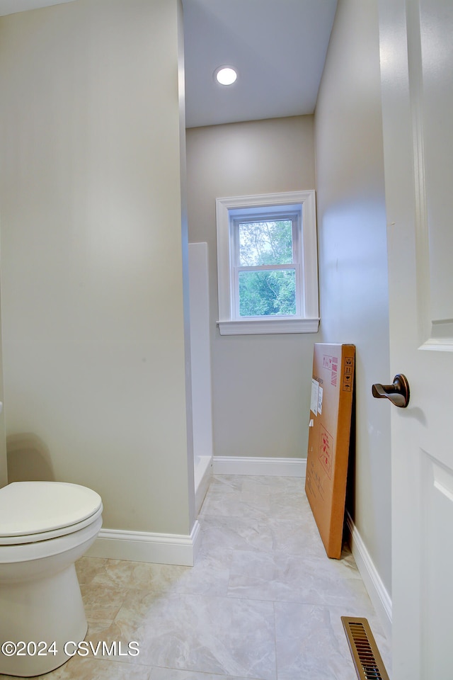 bathroom featuring tile patterned flooring and toilet