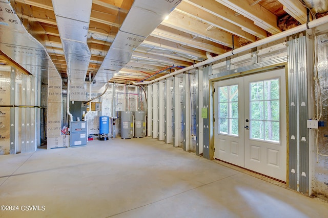 basement featuring water heater and french doors