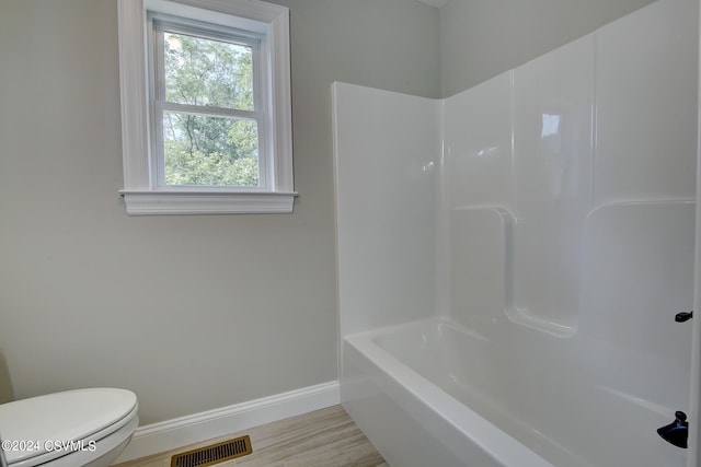 bathroom featuring hardwood / wood-style flooring and toilet