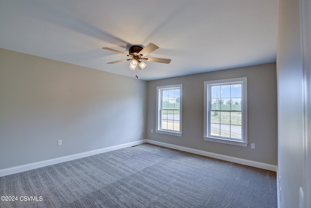 carpeted spare room with ceiling fan