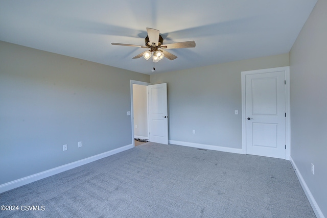 spare room featuring ceiling fan and carpet floors