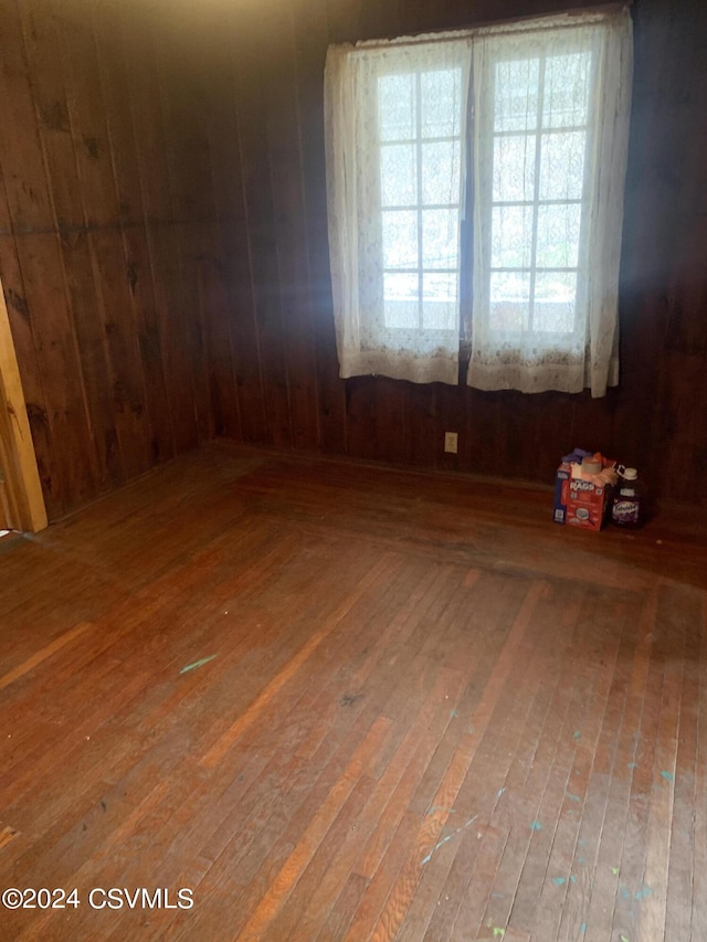 unfurnished room with hardwood / wood-style floors