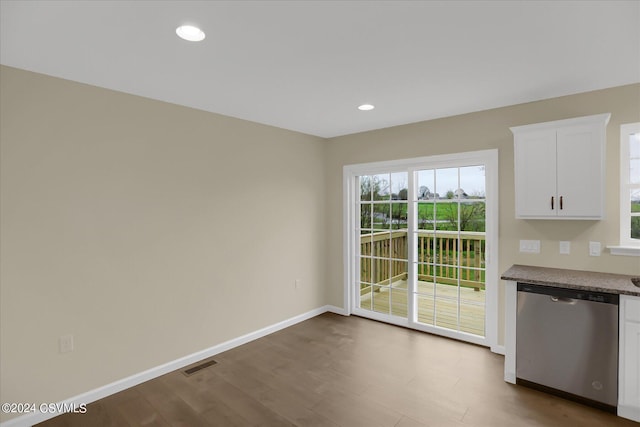 interior space with white cabinetry, dishwasher, and hardwood / wood-style flooring