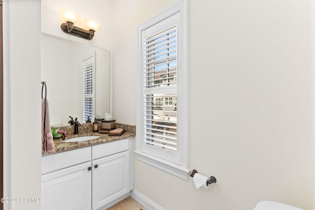 bathroom featuring toilet and vanity