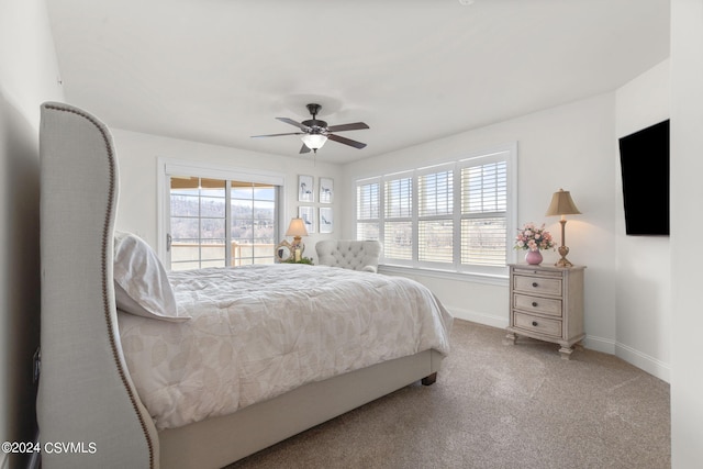 bedroom with light carpet, ceiling fan, and multiple windows