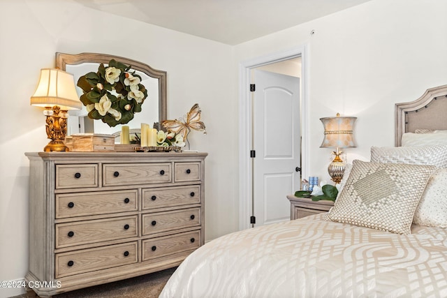 bedroom with dark colored carpet