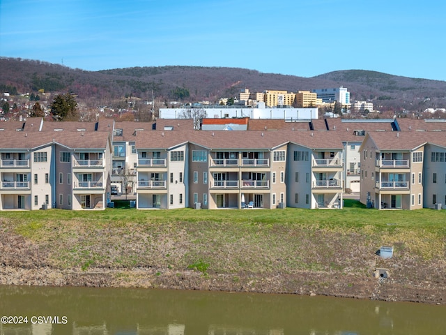 exterior space with a water and mountain view