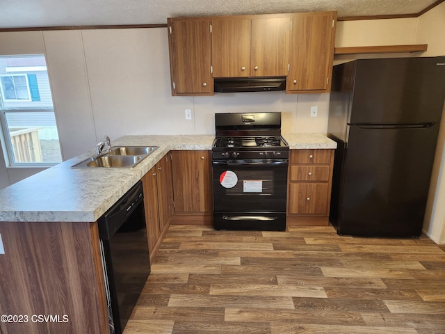 kitchen featuring extractor fan, dark hardwood / wood-style floors, black appliances, and sink