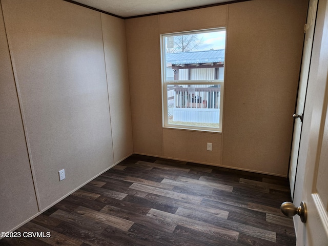 spare room with a textured ceiling and dark hardwood / wood-style floors