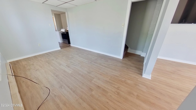 unfurnished bedroom with light hardwood / wood-style floors and a paneled ceiling