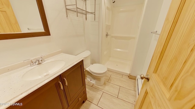 bathroom featuring a shower, oversized vanity, toilet, and tile flooring