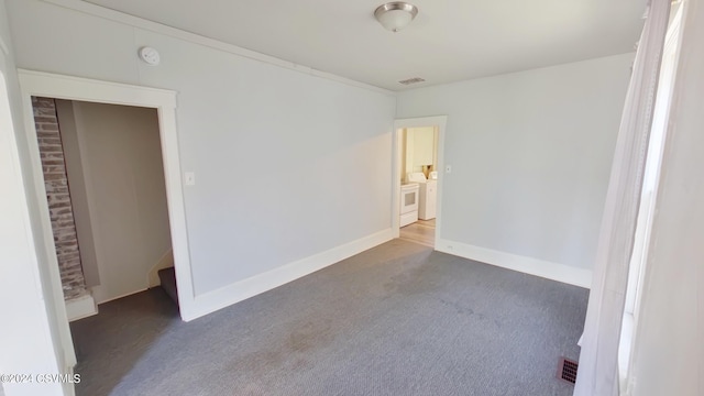 unfurnished room featuring dark carpet