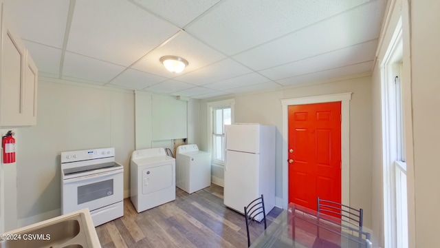 washroom featuring sink, hardwood / wood-style flooring, washer hookup, and washer and clothes dryer