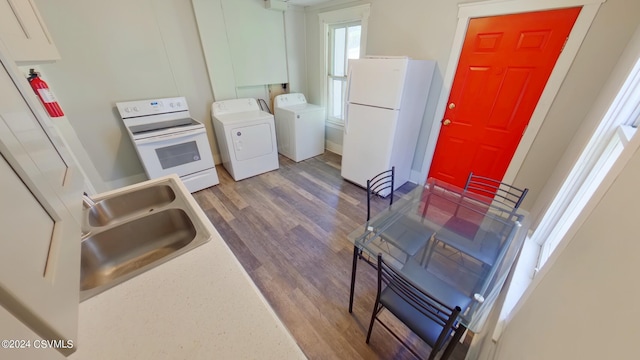 interior space with washer and clothes dryer, dark hardwood / wood-style floors, and sink