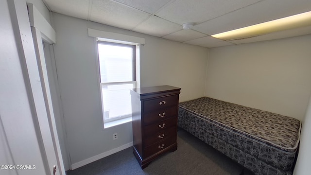 carpeted bedroom with a drop ceiling