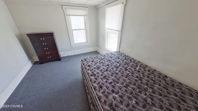 unfurnished bedroom with dark carpet