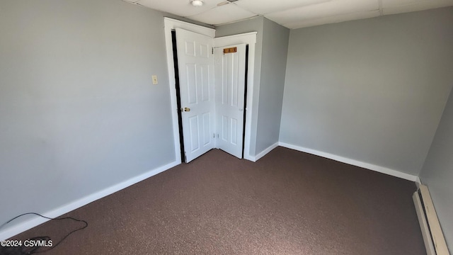 interior space featuring a baseboard radiator and a paneled ceiling