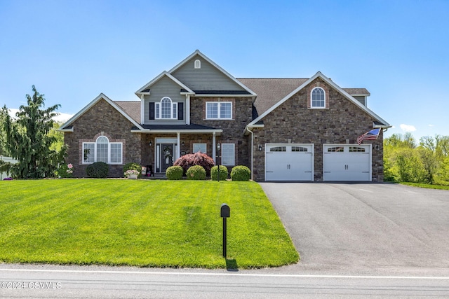 view of front of property featuring a garage and a front lawn