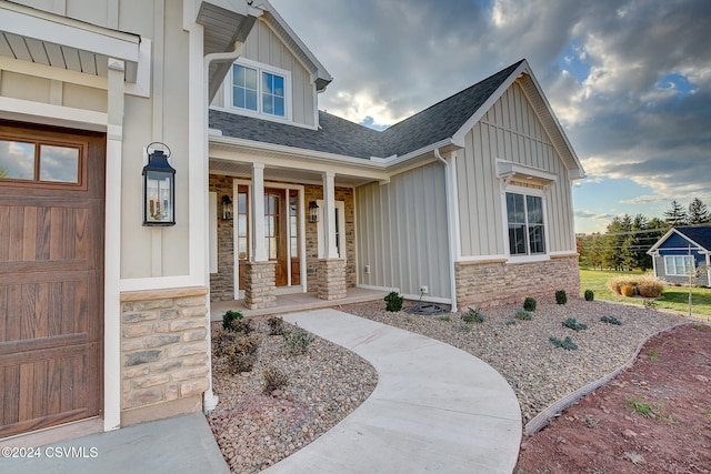 property entrance with covered porch and a garage