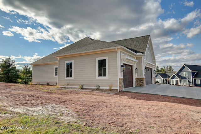 view of side of home featuring a garage