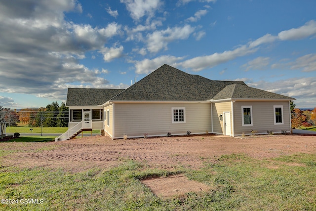 rear view of house with a yard