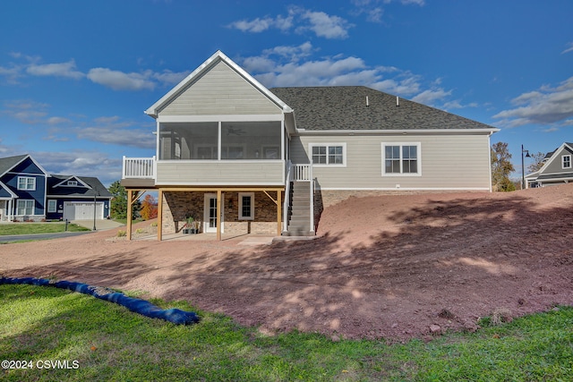 back of property with a sunroom