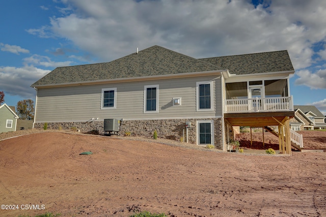 rear view of property with cooling unit