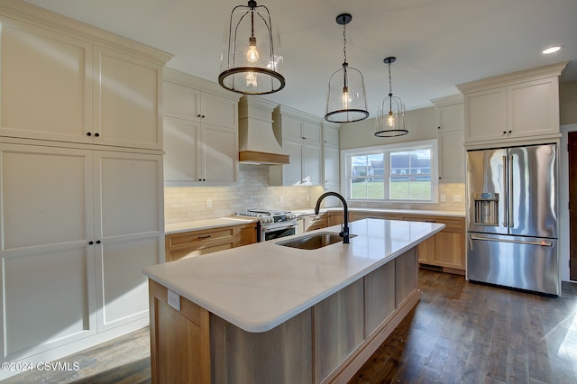 kitchen featuring premium range hood, an island with sink, stainless steel appliances, and dark hardwood / wood-style flooring