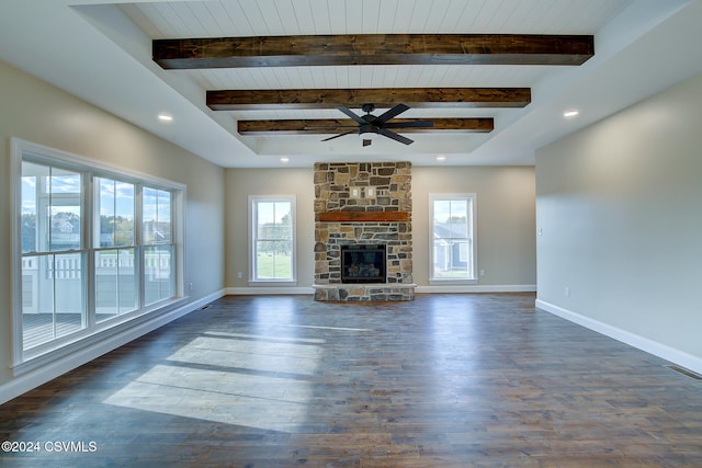 unfurnished living room with beam ceiling, dark wood-type flooring, a fireplace, and ceiling fan